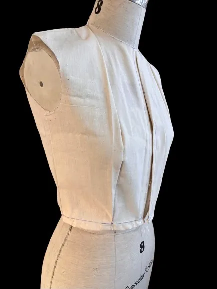 The calico bodice on the dress form, viewed from a three-quarter angle.